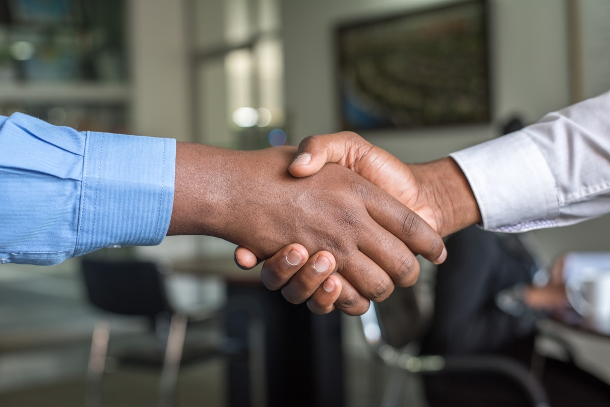 A quiet consultation between counsel and clients across a conference table.
